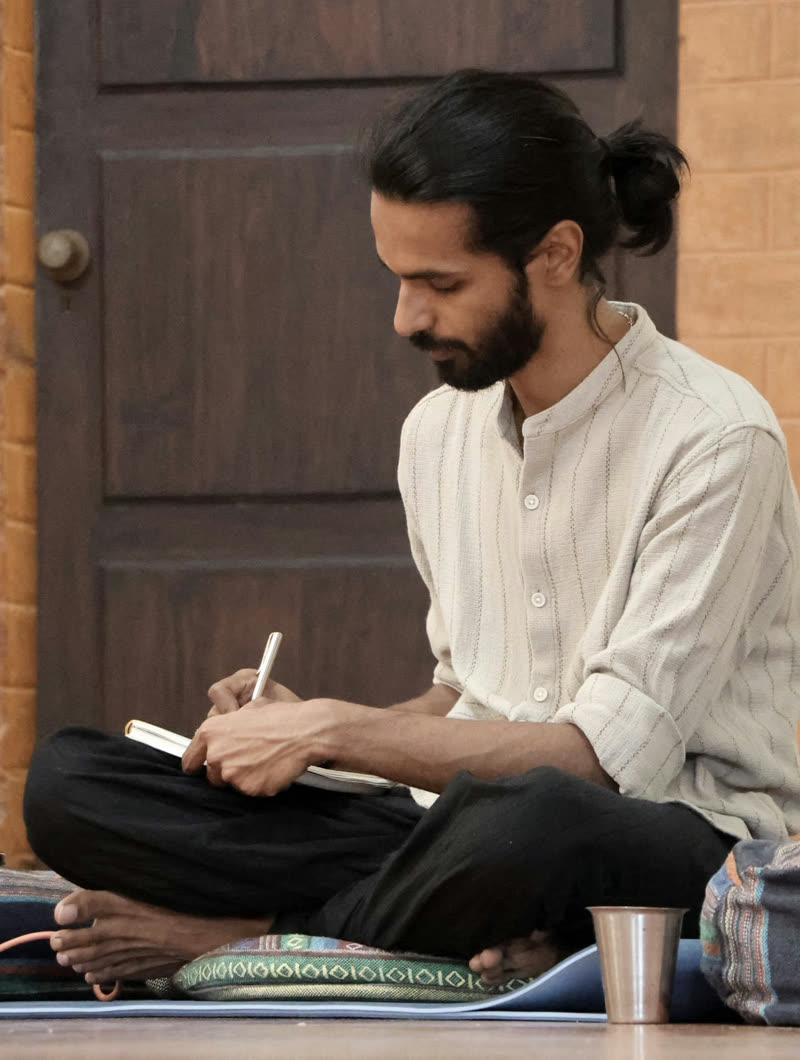 Yash, writing on paper